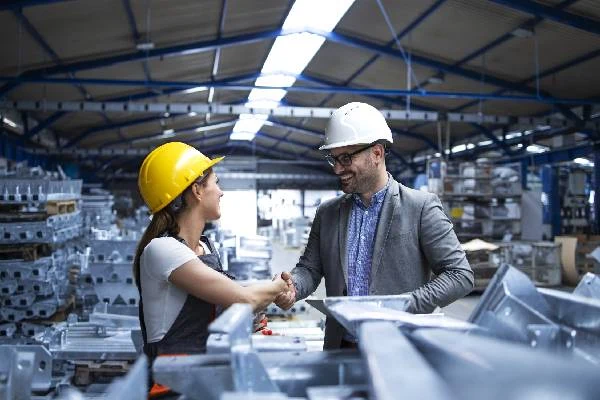 Manufacturing professionals inspecting a metal component